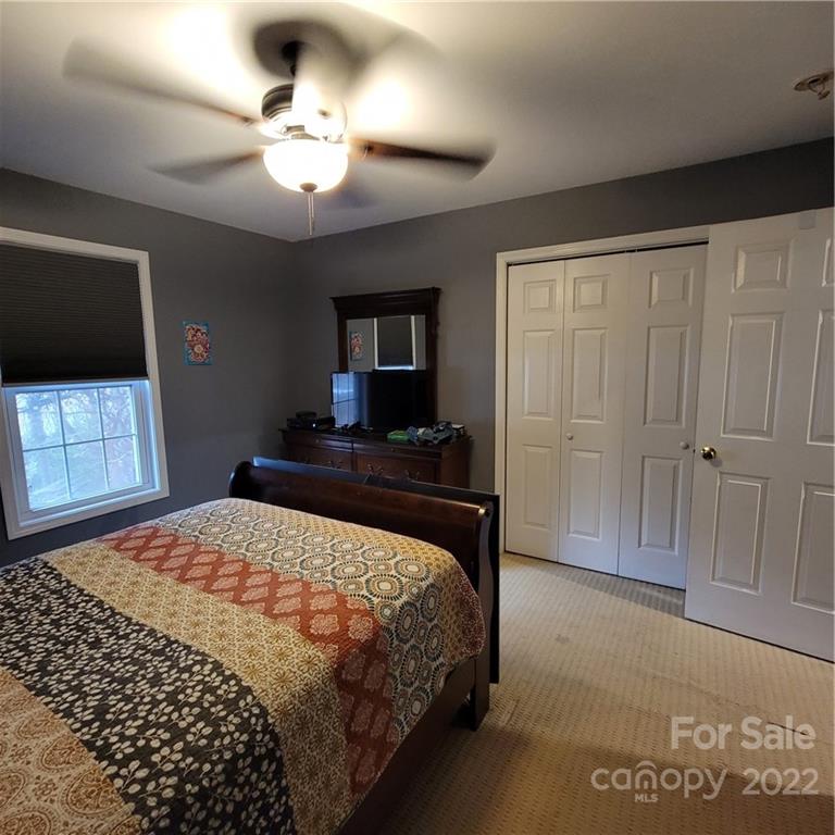 1744 Furnace Road Lincolnton, NC 28092 - Photo 10 of 15 a bedroom with a bed and a flat screen tv