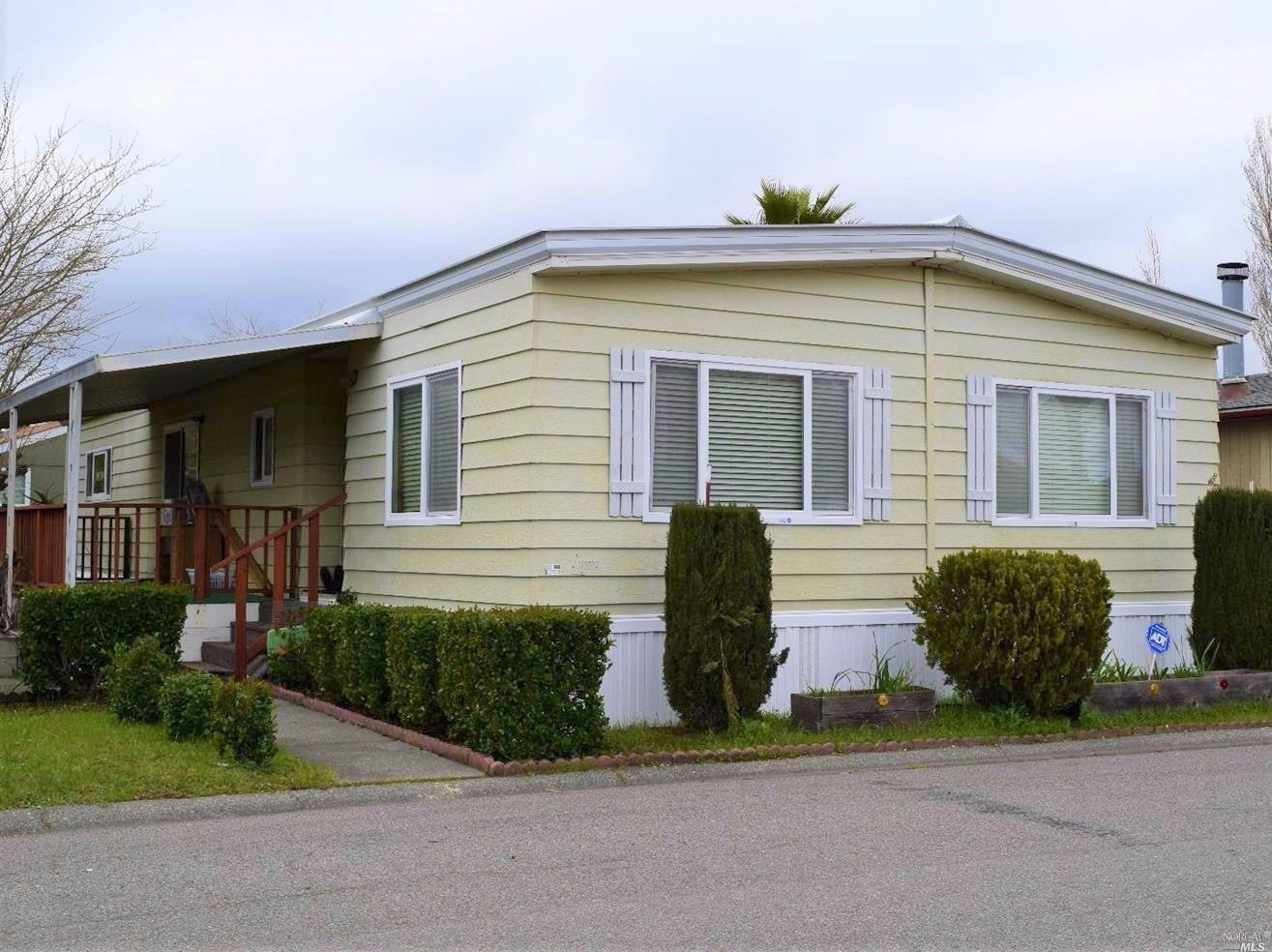 355 Yosemite Road, Unit 355 San Rafael, CA 94903 - Photo 1 of 1 a front view of a house with a yard and potted plants