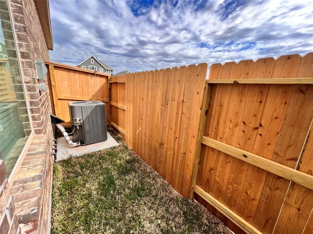 a view of a backyard with wooden fence
