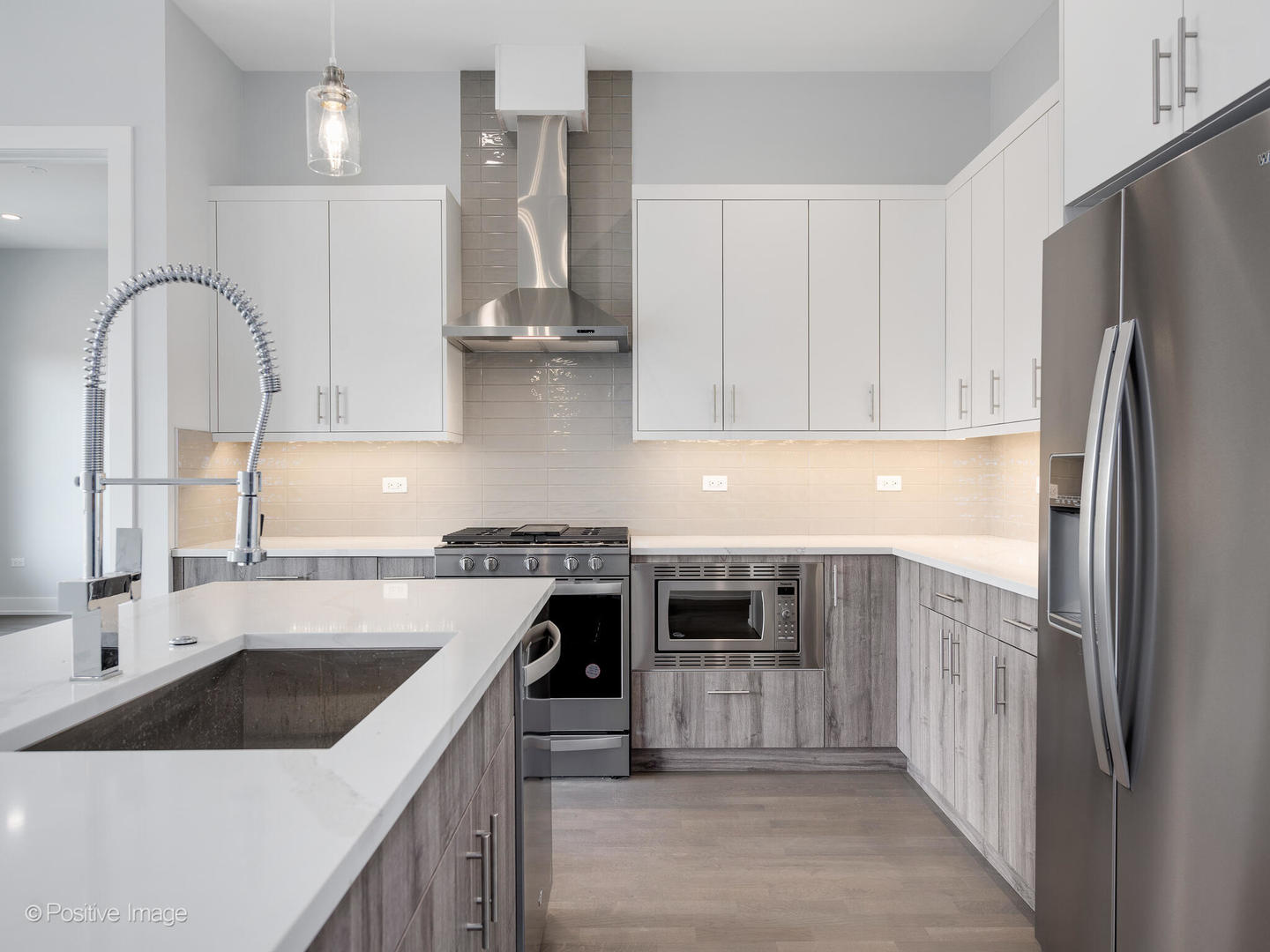 2139 West Madison Street, Unit 212 Chicago, IL 60612 - Photo 2 of 11 a kitchen with stainless steel appliances granite countertop a sink stove and refrigerator