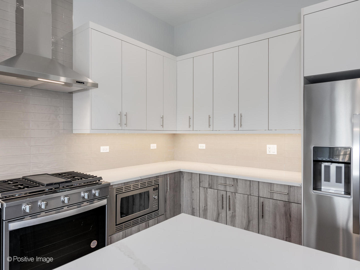 2139 West Madison Street, Unit 212 Chicago, IL 60612 - Photo 4 of 11 a kitchen with stainless steel appliances a stove a refrigerator and cabinets