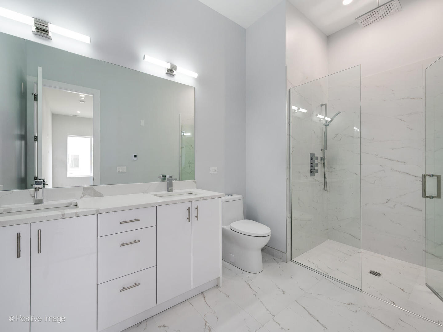 2139 West Madison Street, Unit 212 Chicago, IL 60612 - Photo 7 of 11 a bathroom with a double vanity sink toilet and shower