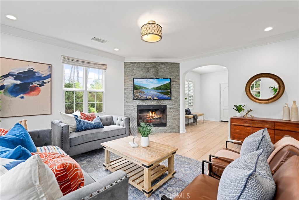 25 Longvale Irvine, CA 92602 - Photo 13 of 58 a living room with furniture a clock and a window