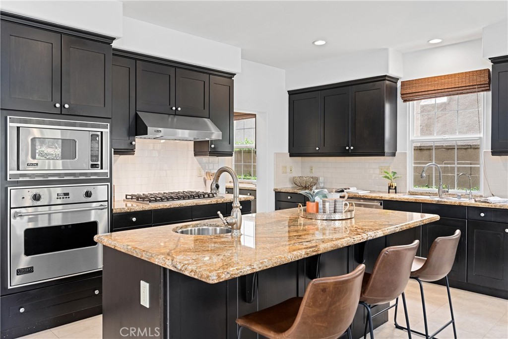 25 Longvale Irvine, CA 92602 - Photo 15 of 58 a kitchen with stainless steel appliances granite countertop a stove a sink and a microwave