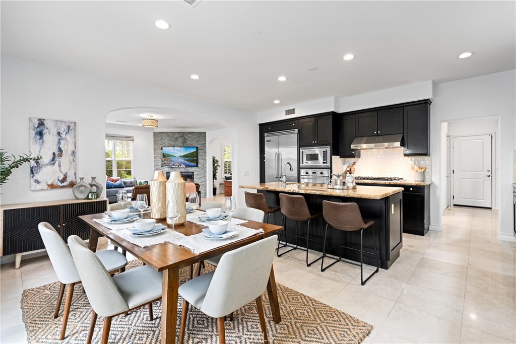 25 Longvale Irvine, CA 92602 - Photo 17 of 58 a dining room with a table chairs and kitchen view