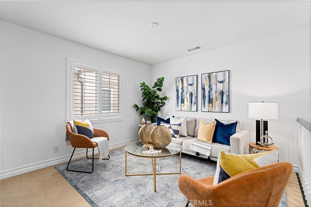 25 Longvale Irvine, CA 92602 - Photo 37 of 58 a living room with furniture and a potted plant