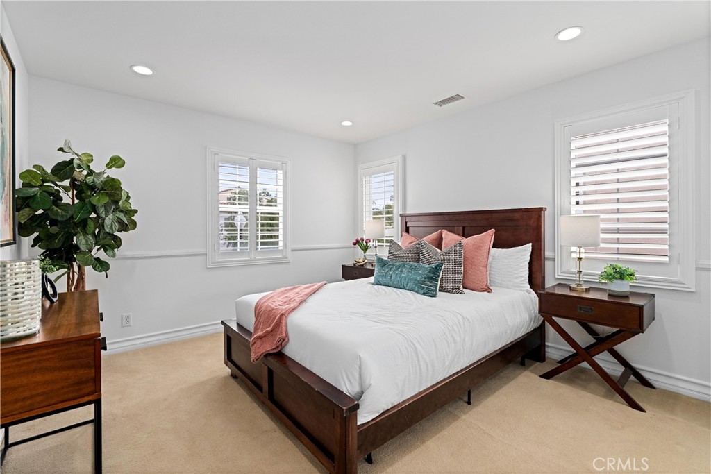 25 Longvale Irvine, CA 92602 - Photo 40 of 58 a bedroom with bed and a potted plant