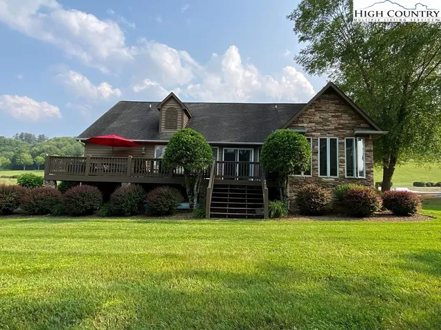 a view of a house with a yard and sitting area