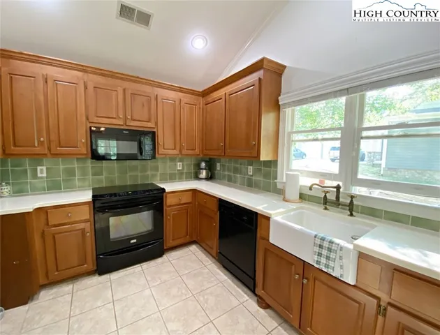 a kitchen with stainless steel appliances granite countertop a stove sink and cabinets