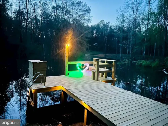 a view of a wooden deck and a patio with swimming pool
