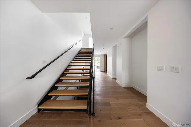 a view of entryway and hall with wooden floor