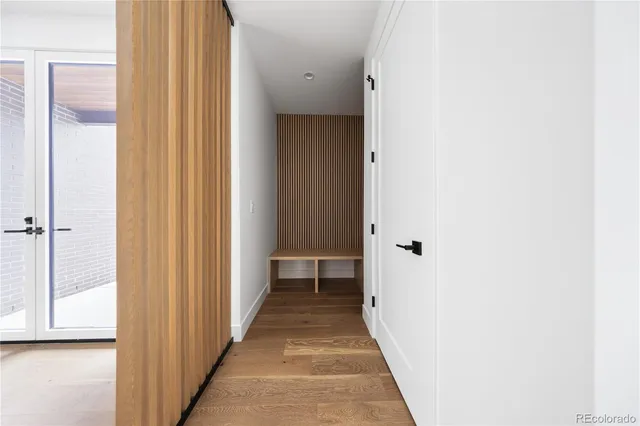 a view of a hallway with wooden floor