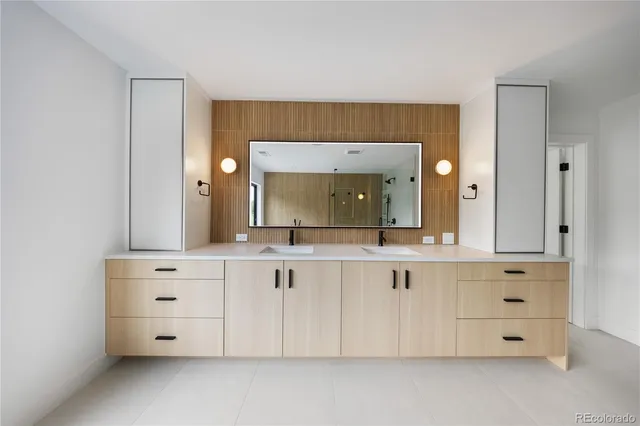 a bathroom with a sink vanity and mirror