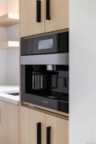 a kitchen with white cabinets and black appliances