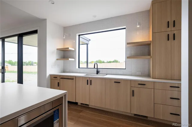a kitchen with a sink cabinets and window