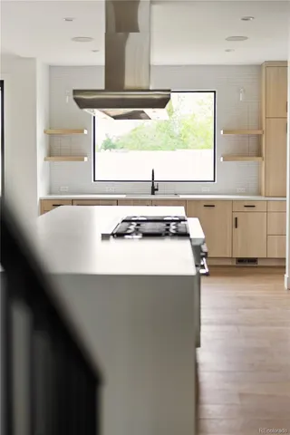 a kitchen with a stove and a window