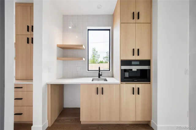 a kitchen with granite countertop a sink and a window