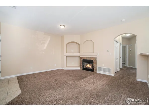 a view of an empty room with a fireplace