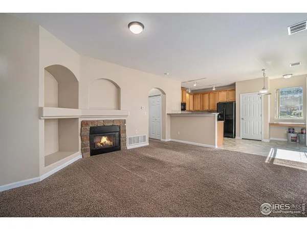 a view of empty room with a fireplace
