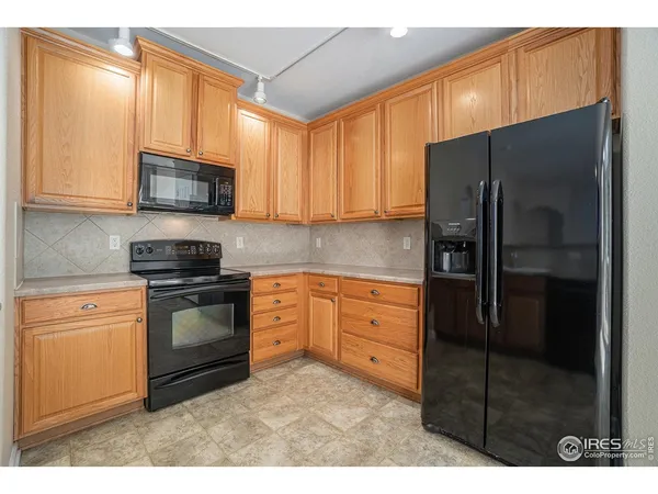 a kitchen with stainless steel appliances granite countertop a refrigerator stove and microwave