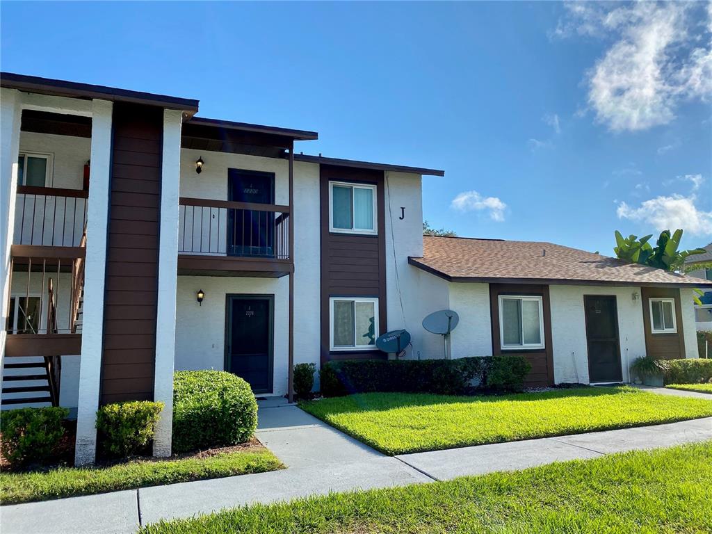 39132 County Road 54, Unit 2230 Zephyrhills, FL 33542 - Photo 1 of 17 a front view of a house with a yard and garage
