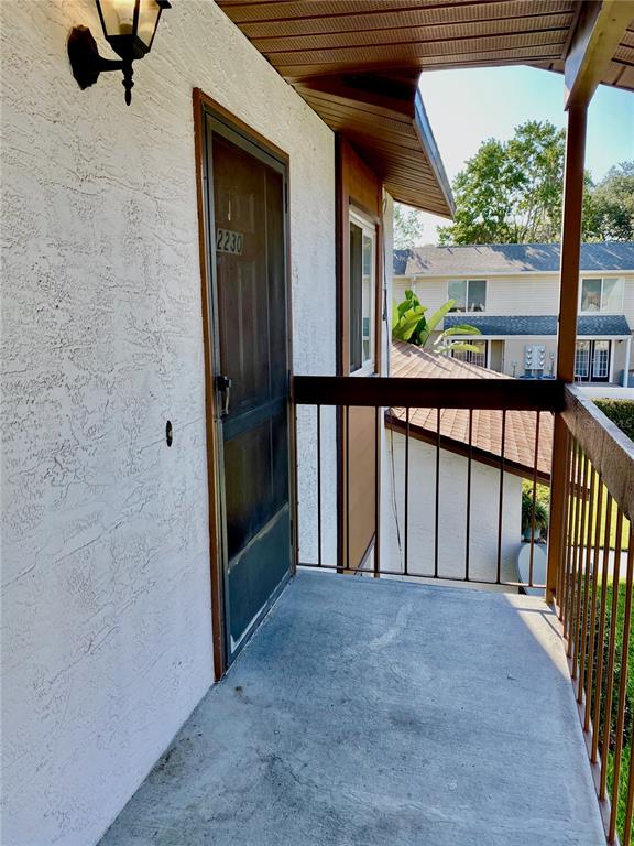 39132 County Road 54, Unit 2230 Zephyrhills, FL 33542 - Photo 2 of 17 a view of balcony with a floor to ceiling window and potted plants