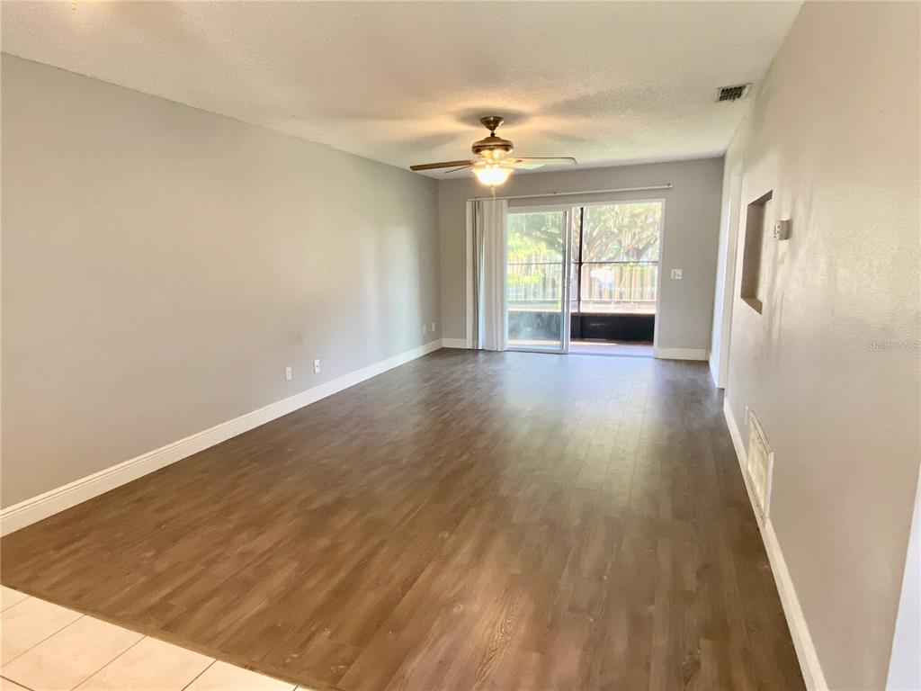 39132 County Road 54, Unit 2230 Zephyrhills, FL 33542 - Photo 8 of 17 wooden floor in an empty room with a window