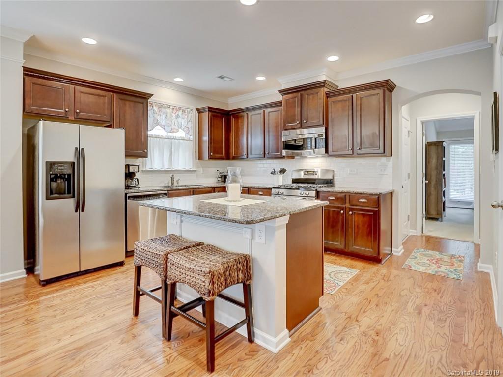 3462 Richard's Crossing Fort Mill, SC 29708 - Photo 17 of 42 a kitchen with stainless steel appliances granite countertop a refrigerator a stove a sink a dining table and chairs