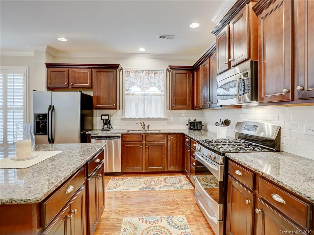 3462 Richard's Crossing Fort Mill, SC 29708 - Photo 18 of 42 a kitchen with stainless steel appliances granite countertop a sink stove microwave and refrigerator