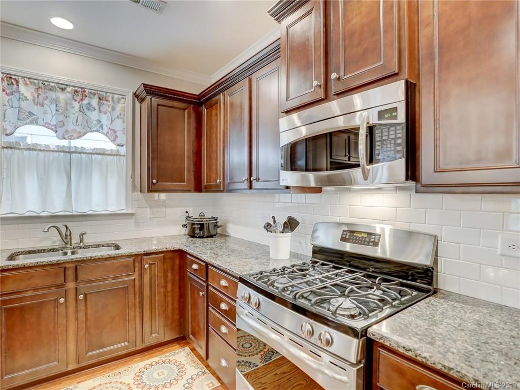 3462 Richard's Crossing Fort Mill, SC 29708 - Photo 19 of 42 a kitchen with stainless steel appliances granite countertop a sink stove and microwave