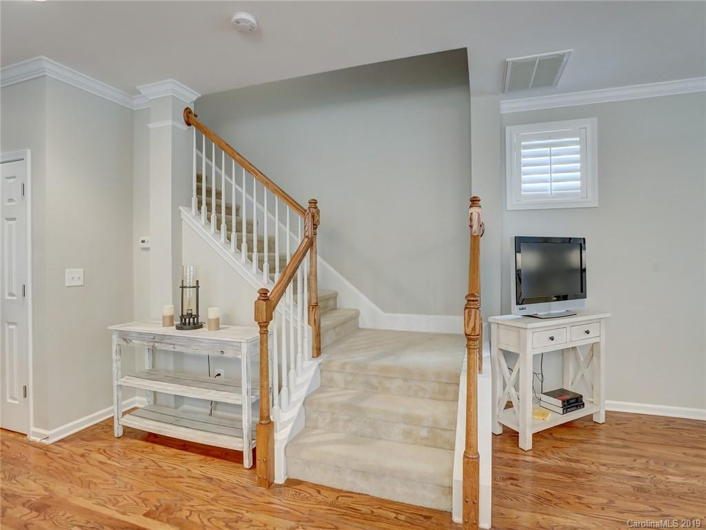 3462 Richard's Crossing Fort Mill, SC 29708 - Photo 24 of 42 a view of a livingroom with wooden floor a flat screen tv and a fireplace
