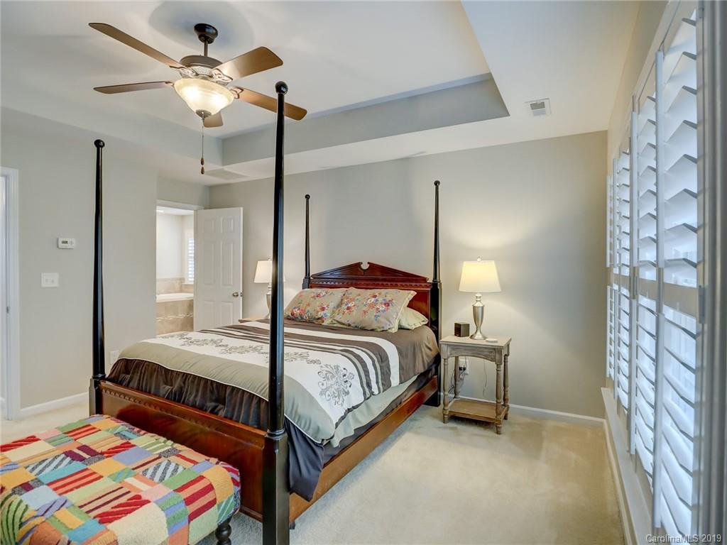 3462 Richard's Crossing Fort Mill, SC 29708 - Photo 27 of 42 a bedroom with a bed and a chandelier