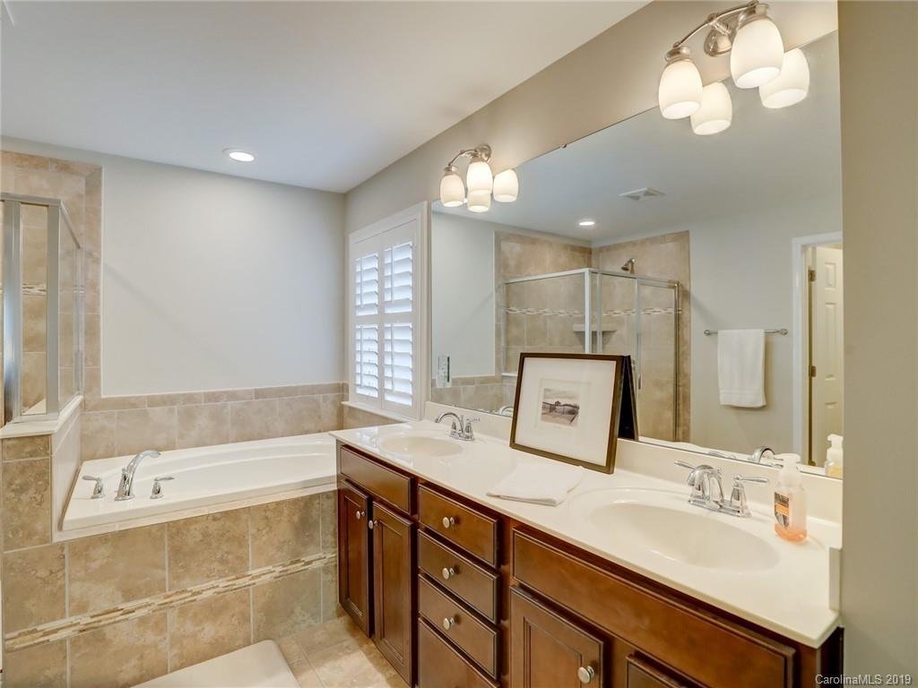 3462 Richard's Crossing Fort Mill, SC 29708 - Photo 29 of 42 a bathroom with a sink a large mirror and a bathtub