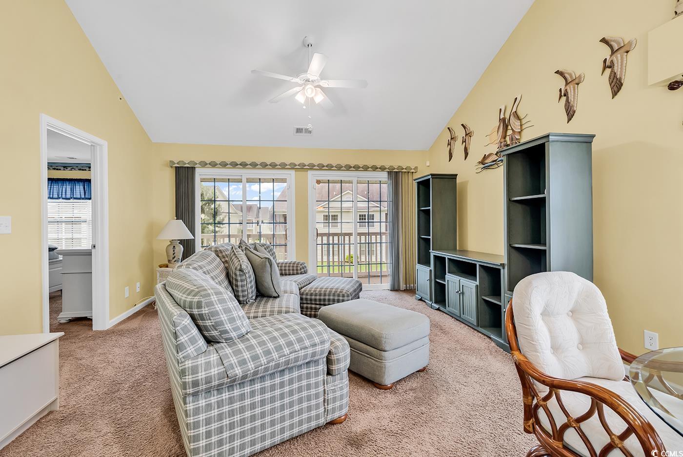 4909 Britewater Court, Unit 202 Myrtle Beach, SC 29579 - Photo 13 of 38 Living room with light colored carpet, ceiling fan, and high vaulted ceiling