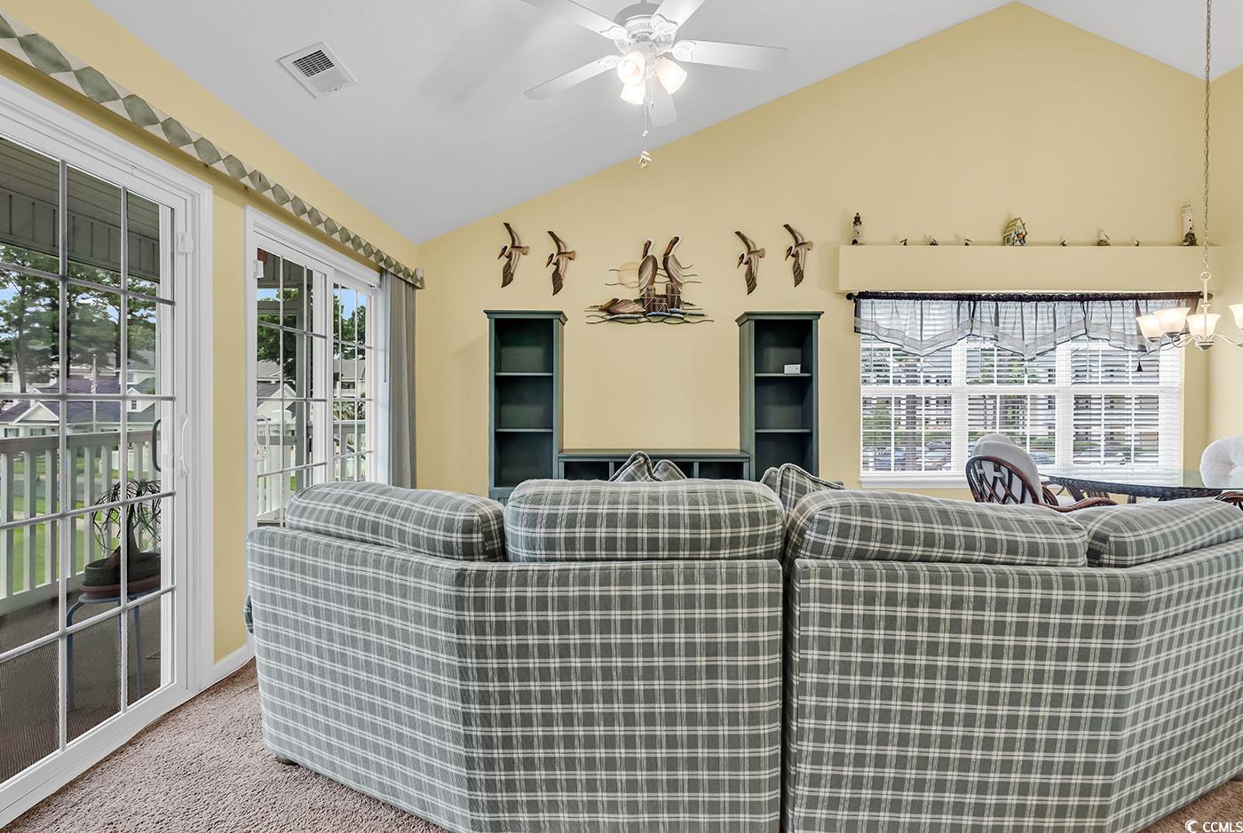 4909 Britewater Court, Unit 202 Myrtle Beach, SC 29579 - Photo 14 of 38 Living area with vaulted ceiling, carpet, and ceiling fan