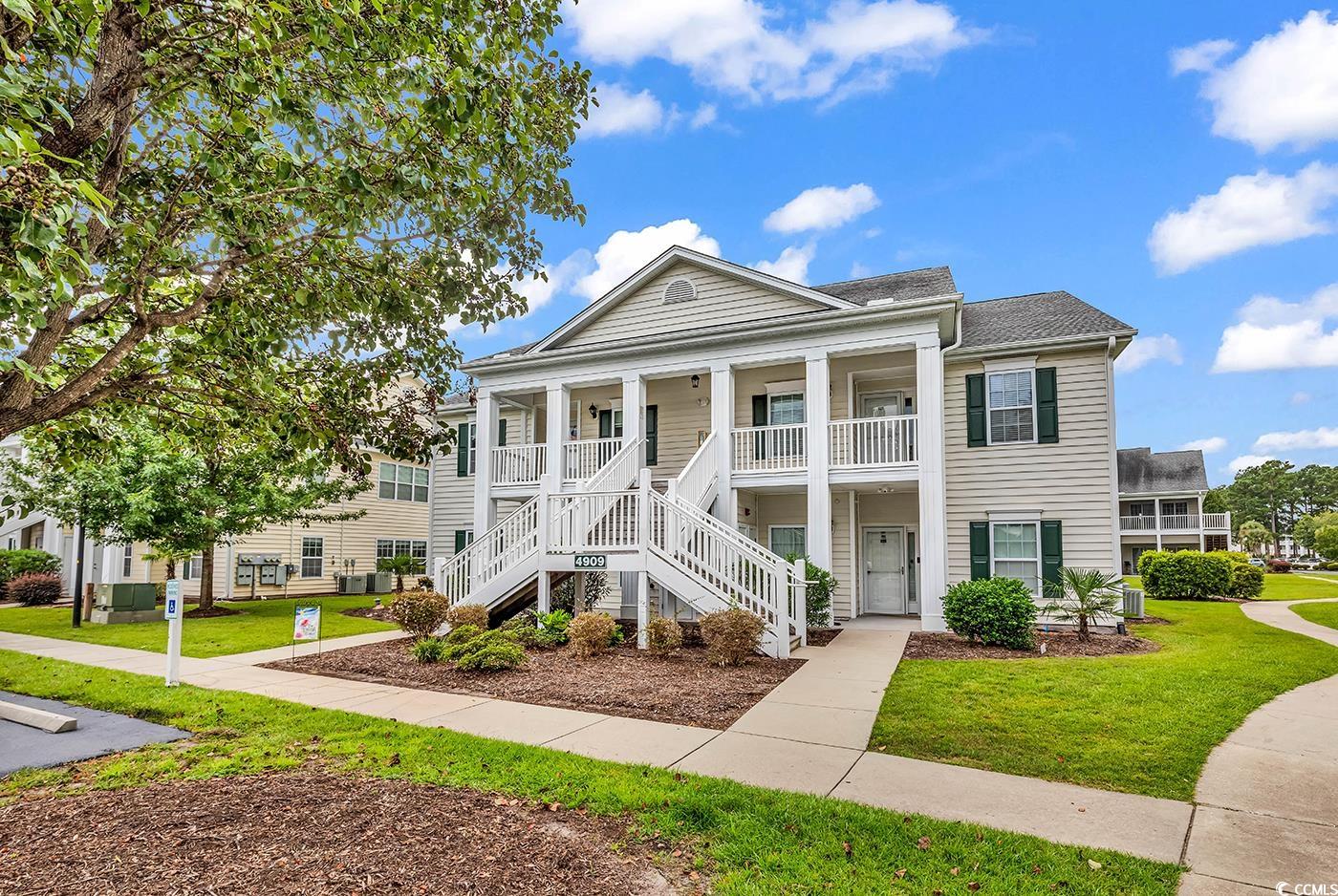 4909 Britewater Court, Unit 202 Myrtle Beach, SC 29579 - Photo 2 of 38 View of front facade featuring stairs, a porch, and a front yard