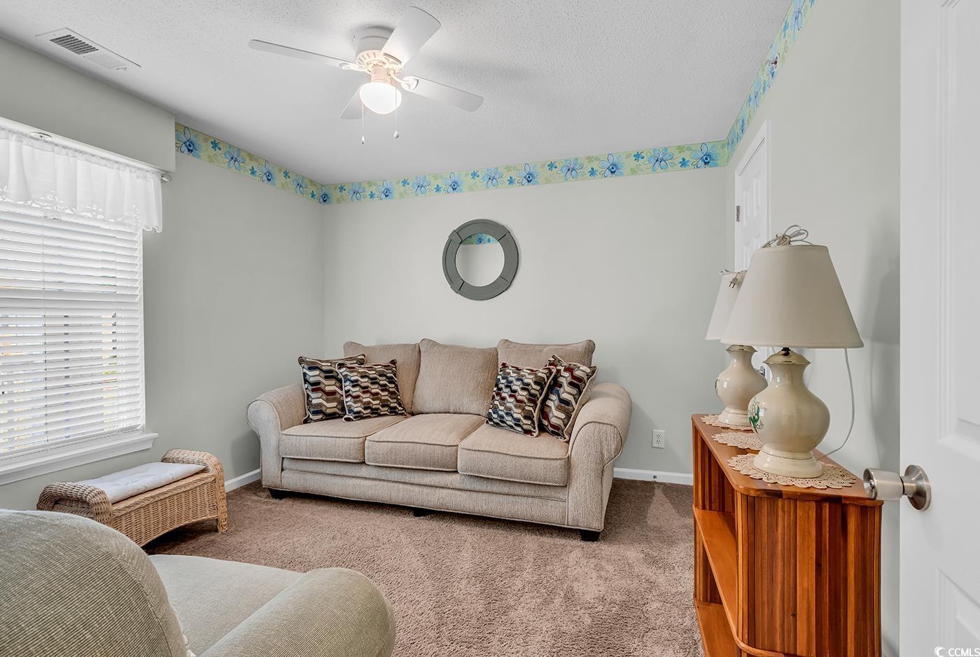 4909 Britewater Court, Unit 202 Myrtle Beach, SC 29579 - Photo 3 of 38 Carpeted living room featuring a textured ceiling and ceiling fan