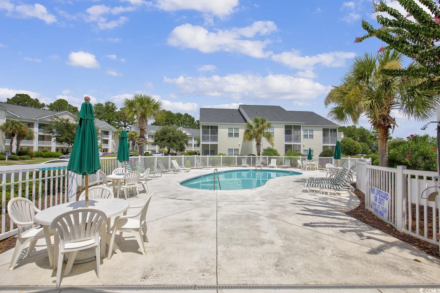 4909 Britewater Court, Unit 202 Myrtle Beach, SC 29579 - Photo 35 of 38 Community pool with a patio