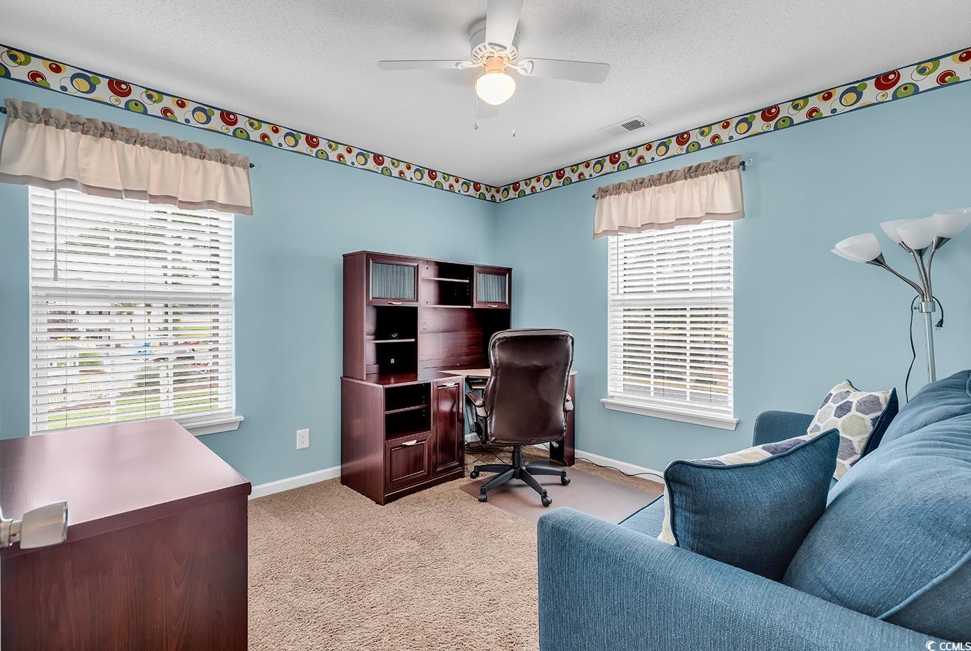 4909 Britewater Court, Unit 202 Myrtle Beach, SC 29579 - Photo 6 of 38 Home office featuring light carpet, a ceiling fan, and a textured ceiling. It's bedroom 2 of 3 being used as home office.