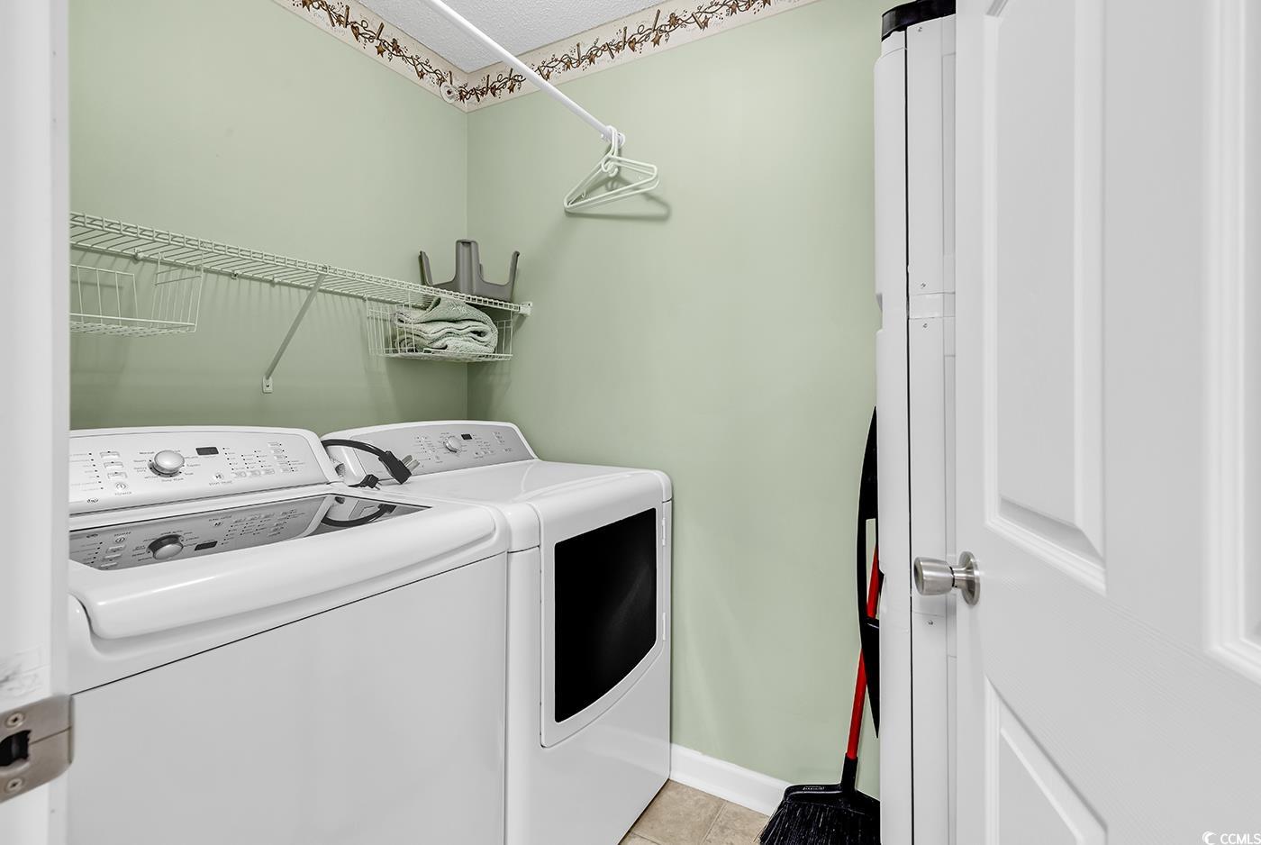 4909 Britewater Court, Unit 202 Myrtle Beach, SC 29579 - Photo 10 of 38 Washroom featuring washing machine and clothes dryer and light tile patterned flooring