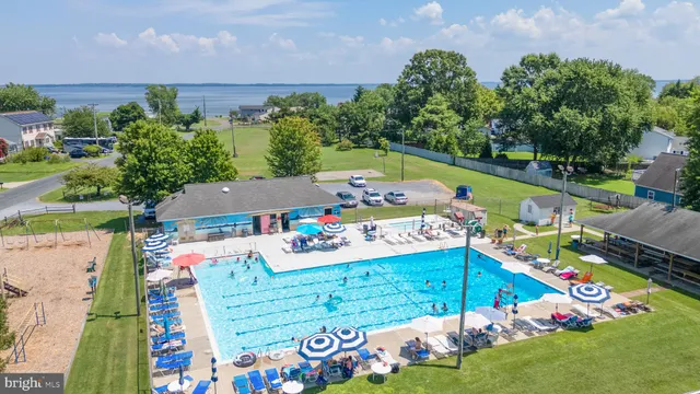 an aerial view of a house with a yard and lake view