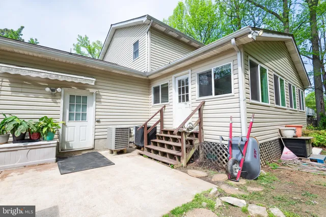 a view of a backyard with a garden and trees
