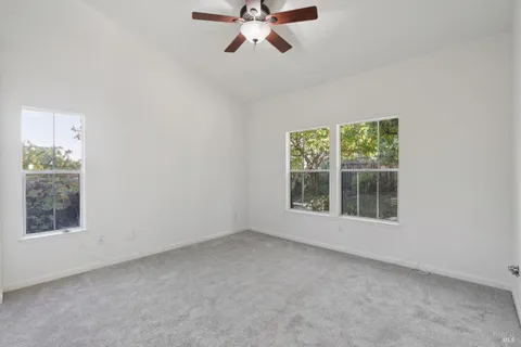a view of an empty room with closet area