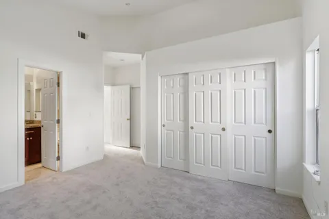 a bathroom with a granite countertop shower sink and mirror