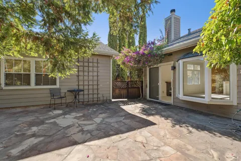 a view of a backyard with table and chairs and potted plants