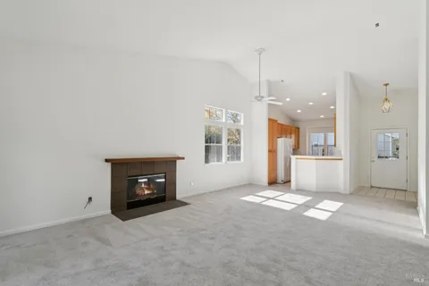 a view of a big room with windows and fireplace