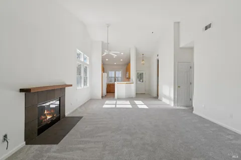 a view of a livingroom with a fireplace and window