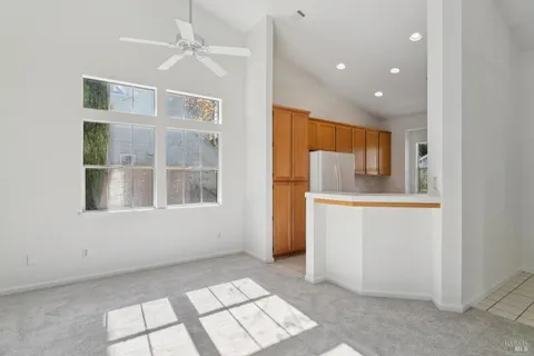 a kitchen with stainless steel appliances granite countertop white cabinets and window