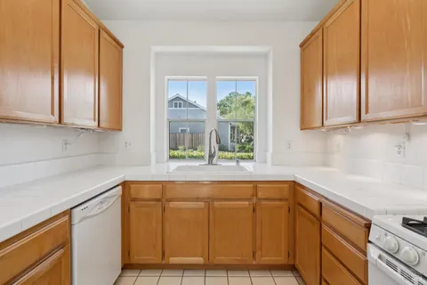 a kitchen with a stove a sink and a microwave