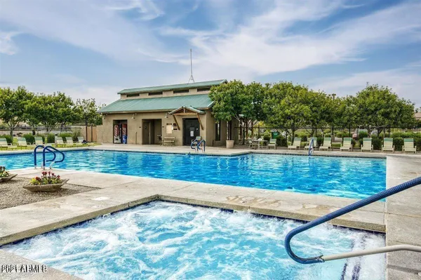a view of swimming pool with seating area